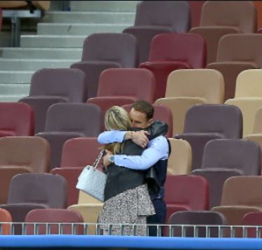 Alison Southgate and Gareth Southgate hugging each other at a stadium